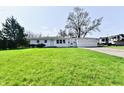 Charming single-story home with a well-manicured lawn and an attached two car garage at 3015 E Sumner Ave, Indianapolis, IN 46237