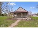 Charming home with a covered porch, complemented by lovely landscaping and a brick pathway at 3070 N Layman Ave, Indianapolis, IN 46218