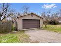 Spacious two-car detached garage with a gravel driveway and a gated entry at 3070 N Layman Ave, Indianapolis, IN 46218