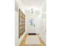 Bright entryway with hardwood floors, a decorative mirror, and a welcoming entrance at 5072 Astor Way, McCordsville, IN 46055