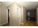 Hallway featuring neutral paint, vinyl floors, and doors leading to other rooms in the home at 5406 Shamus Dr, Indianapolis, IN 46235