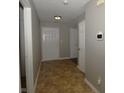 Hallway featuring neutral paint, tile floors, and doors leading to other rooms in the home at 5406 Shamus Dr, Indianapolis, IN 46235