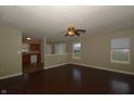 Open-concept living room with ceiling fan, wood floors, and natural light at 5406 Shamus Dr, Indianapolis, IN 46235