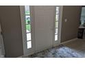 Interior view of front door with sidelights and decorative rug at 561 Prince Dr, Greenwood, IN 46142