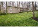 Stone house with a well-maintained lawn and lush greenery at 5918 Camelback Ct, Indianapolis, IN 46250