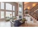 Bright living room with large windows, a fireplace, and comfortable seating at 633 Foxboro Dr, Avon, IN 46123