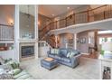 Spacious living room boasting a cozy fireplace, elegant staircase, and comfortable seating arrangement at 633 Foxboro Dr, Avon, IN 46123
