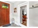 Bright foyer with a stylish wooden door, lantern, and view into a modern office space at 634 Dorman St, Indianapolis, IN 46202