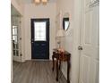 Inviting entryway with stylish floors, decorative table, and laundry room access at 7527 Derek Dr, Camby, IN 46113