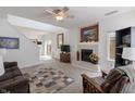 Open-concept living room with a fireplace, skylight, plush carpeting and a comfortable seating arrangement at 768 Pine Lake Dr, Greenwood, IN 46143