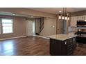 Inviting living room with hardwood floors, stainless steel appliances, and a kitchen island at 7809 Bryden Dr, Fishers, IN 46038