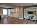Spacious living room featuring hardwood floors and custom built-in cabinets at 7809 Bryden Dr, Fishers, IN 46038