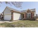 Charming home with brick and siding, attached garage, and well-maintained lawn at 855 Queensgate Dr, Greenwood, IN 46143