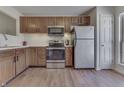 Cozy kitchen featuring wood cabinets, stainless steel appliances, and a white subway tile backsplash at 855 Queensgate Dr, Greenwood, IN 46143