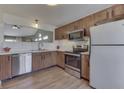 Well-lit kitchen features wood cabinets, stainless steel appliances, and bright countertops at 855 Queensgate Dr, Greenwood, IN 46143