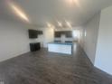 Open-concept kitchen with dark cabinetry, a light blue countertop, and hardwood floors at 8727 Duncan St, Fortville, IN 46040