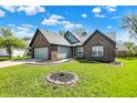 Well-maintained home with a two-car garage, brick accents, and beautifully landscaped front yard at 8807 Wintergreen Way, Indianapolis, IN 46256