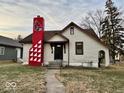 Charming one story home featuring a bold chimney design and dormant lawn at 921 W Carson St, Muncie, IN 47303