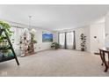 Open-concept living room with neutral carpet, abundant natural light, and elegant decor, perfect for entertaining at 10221 Tournon Dr, Fishers, IN 46037