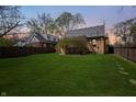 Expansive backyard featuring lush green grass, surrounded by mature trees, offering a serene outdoor space at 1025 E 60Th St, Indianapolis, IN 46220
