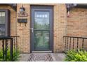 Inviting front entrance with a glass storm door, showcasing a welcoming 'Home Sweet Home' door mat at 1025 E 60Th St, Indianapolis, IN 46220