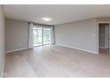 Empty living room showing flooring, neutral paint and natural light from the patio door at 1044 Timber Creek Dr # 4, Carmel, IN 46032