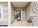 View of the covered front porch, featuring the home's address and a decorative sun ornament at 11182 Black Gold Dr, Noblesville, IN 46060