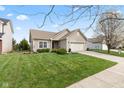 Attractive home with a green lawn and landscaping that accents the light-colored exterior at 11182 Black Gold Dr, Noblesville, IN 46060