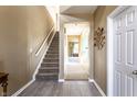 Hallway view with stairs, neutral paint, tile flooring, and an open doorway to another room at 11958 Logan Hunter Trl, Noblesville, IN 46060