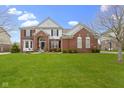 Charming two-story brick home with a well-maintained lawn and mature landscaping in a suburban neighborhood at 12030 Auburn Creek, Zionsville, IN 46077