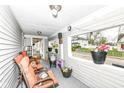 Cozy porch with orange chairs, plants, and a view of the neighborhood at 1270 Eugene St, Indianapolis, IN 46208