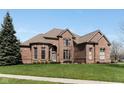 Elegant brick residence boasts lush green lawn and manicured shrubs at 13214 Mink Ln, Carmel, IN 46074