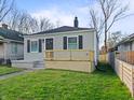 Charming single-story home featuring a neat front yard, gray siding, a small porch, and black shutters at 1331 W 33Rd St, Indianapolis, IN 46208