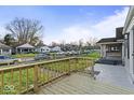 Inviting front porch with wooden railing offers a view of the neighborhood street at 1331 W 33Rd St, Indianapolis, IN 46208