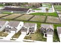 An aerial view showcases the home's location near equestrian facilities, paddocks, and some standing water, a creek, or low-lying area at 1455 Bigleaf Dr, Sheridan, IN 46069