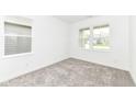 Minimalist bedroom with neutral carpet, white walls, and natural light from two windows at 159 Derringer Ave, Westfield, IN 46074
