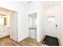 Bright entryway featuring wood-look flooring, a white front door, and access to a bathroom and bedroom at 159 Derringer Ave, Westfield, IN 46074