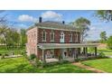 Beautiful exterior shot of the home with large front yard and inviting front porch with seating at 1901 S Old State Road 67, Paragon, IN 46166