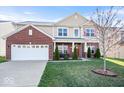 Beautiful two-story home featuring brick and siding exterior, a two-car garage, and a cozy front porch at 1907 Wedgewood Pl, Avon, IN 46123