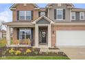 Inviting front entry with decorative wreath, covered porch, and brick facade for a charming curb appeal at 2736 Victory Dr, Columbus, IN 47203