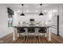 Kitchen island featuring white cabinets, black countertop, and pendant lights at 2736 Victory Dr, Columbus, IN 47203