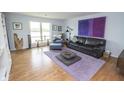 Spacious living room features hardwood floors, a contemporary rug, and plenty of comfortable seating at 3004 Lake Shore Dr # E, Indianapolis, IN 46205