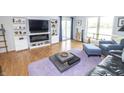 Open-concept living room with built-in shelving, hardwood floors, and plenty of space to relax at 3004 Lake Shore Dr # E, Indianapolis, IN 46205
