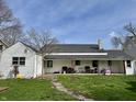 Spacious backyard featuring a well-maintained lawn and a covered patio area at 323 E Adams St, Franklin, IN 46131