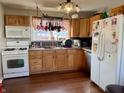 Functional kitchen with appliances, ample cabinetry and hardwood floors at 323 E Adams St, Franklin, IN 46131