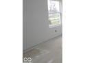 Bright, unfinished bedroom with freshly painted white walls and baseboards; a single window allows for plenty of natural light at 3941 Highcrest Rd, Indianapolis, IN 46239