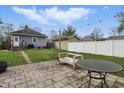 Lush backyard with a combination of stone patio and grassy areas, ideal for relaxing and gathering at 4815 Winthrop Ave, Indianapolis, IN 46205