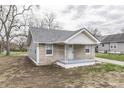 Quaint home featuring stone accents, vinyl siding, and a charming front porch area at 4945 Camden St, Indianapolis, IN 46227