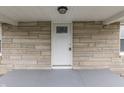 A welcoming front door with stone accents and a charming porch area at 4945 Camden St, Indianapolis, IN 46227