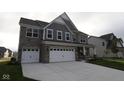 Charming two-story home boasting stone and shingle siding, a two-car garage, and a wide driveway at 4952 Cinnabar Trl, Brownsburg, IN 46112